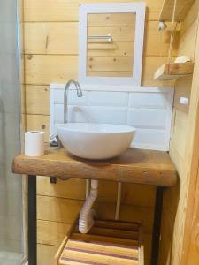 a bathroom with a white sink on a wooden table at Cabaña abundancia in El Palmar