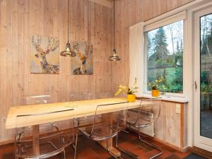 a kitchen with a table and chairs and a window at 8 person holiday home in Ebeltoft in Ebeltoft