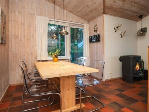 a dining room with a wooden table and chairs at 8 person holiday home in Ebeltoft in Ebeltoft