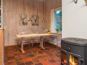 a kitchen with a table and chairs and a stove at 8 person holiday home in Ebeltoft in Ebeltoft