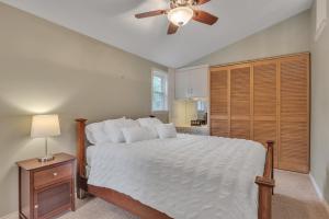 Schlafzimmer mit einem Bett und einem Deckenventilator in der Unterkunft Amazing Lakefront Retreat On Long Lake! home in Portage