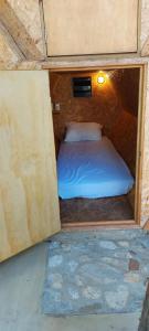 a small room with a bed in the middle at Bugambilias Alojamiento in Brisas de Zicatela