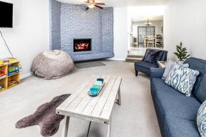 a living room with a couch and a fireplace at Midtown Anchorage Basecamp Condo A in Anchorage