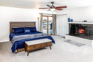 a bedroom with a bed and a fireplace at Midtown Anchorage Basecamp Condo A in Anchorage