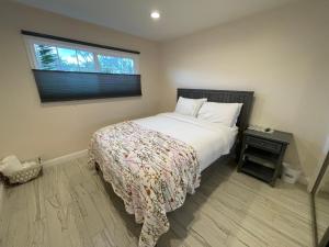 a bedroom with a bed and a window at Cheerful, Beautifully Remodeled, Modern, Comfortable Home in Los Angeles