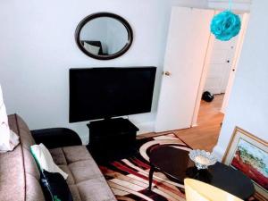 a living room with a flat screen tv and a couch at Cozy Apartment Easy Transportation 2 New York City in West New York