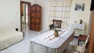 a living room with a table with flowers on it at Departamentos extension Casa Paraíso in Manta +23 photos