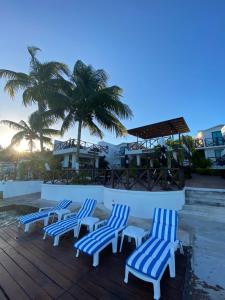 a group of blue chairs sitting on a deck at Hotel Aldea 19 Bacalar in Bacalar