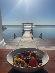 a bowl of food sitting on top of a wooden table at Hotel Aldea 19 Bacalar in Bacalar