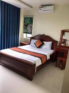 Ένα ή περισσότερα κρεβάτια σε δωμάτιο στο Nam Phong Hotel