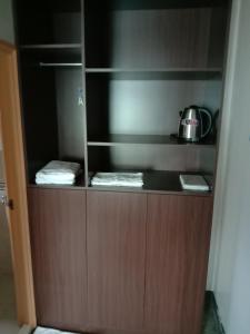 a kitchen with a cupboard with a tea kettle on it at 雲台客棧民宿 in Nangan