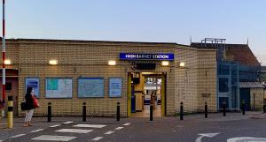 a woman standing in front of a brick building at Lovely 1 bedroom flat High Barnet 3 mins away in Barnet