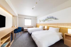 Tempat tidur dalam kamar di THE HAPPO by Hakuba Hotel Group