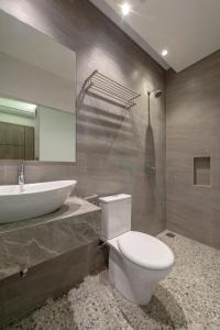 a bathroom with a white toilet and a sink at Livinn Juanda Airport Surabaya in Sidoarjo