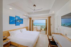 En eller flere senge i et værelse på Luau Beach Inn, Maldives