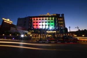 a building with colorful lights on it at night at Ankawa Royal Hotel & Spa in Erbil