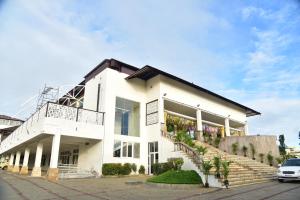 a white building with stairs in front of it at Vistar Suites in Bangalore