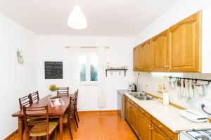 a kitchen with a table and a dining room at Country Home Matkovic - Duba in Čilipi