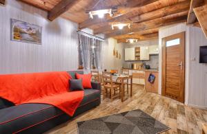 a living room with a couch and a kitchen at Ostoja Bieszczady in Lutowiska