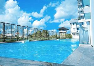 a swimming pool on the side of a building at X-pressbedroom Vivo-Jogja in Seturan