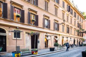 a person walking down a street next to a building at Frezza's Holidays in Rome