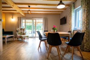 a living room with a table and chairs at Sun House in Nadole