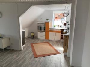 a living room with a kitchen and an attic at Apartment zur Schuntermühle in Lehre