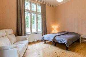a living room with a couch and a bed at Johtola in Mikkeli
