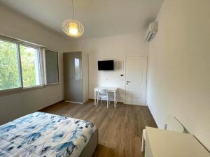 a bedroom with a bed and a table in it at La Casa degli Artisti in Castel Maggiore
