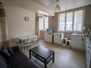 a living room with a couch and a table at Appartement Mont Dore face aux Thermes - Centre in Le Mont-Dore