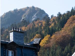 a house with a mountain in the background at Appartement Mont Dore face aux Thermes - Centre in Le Mont-Dore