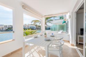 une salle à manger blanche avec une table et des chaises blanches dans l'établissement Apartment Sa Caseta 2 by Mallorca House Rent, à Portopetro 16 autres photos
