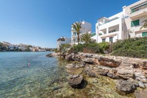 een uitzicht op het water voor sommige gebouwen bij Apartment Sa Caseta 2 by Mallorca House Rent in Portopetro