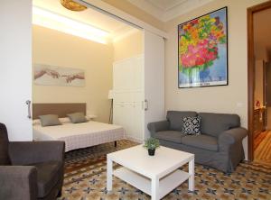 a living room with a bed and a couch at GIRONA - Modernist apartments next to Paseo de Gracia in Barcelona