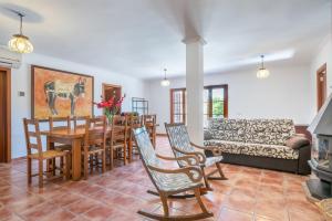 a living room with a table and chairs and a couch at Villa Es Turrió by Mallorca House Rent in Son Carrió