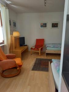 a living room with a couch and a chair at Apartments Ho30 in Stuttgart