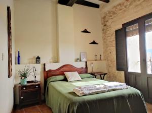 DurónCasa Rural El Botánico的一间卧室配有一张带绿色床单的床和一扇窗户。 更多37张照片