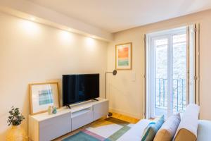 a living room with a tv and a couch at Clérigos Tower - Experience in Porto in Porto