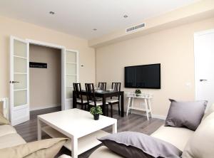a living room with a couch and a table at RIUS - Apartments & one Penthouse with private terrace in Montjuic in Barcelona