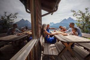 a group of people sitting at a table eating food at Egarterhof in San Candido