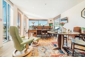 a living room with a table and chairs at Lanah Residence in Queenstown