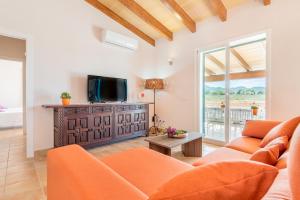 a living room with a couch and a tv at Finca Ca'n Fures in Felanitx
