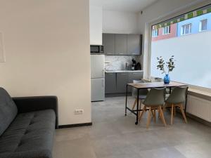 a living room with a table and a kitchen at 2-Zimmer-Appartment in Top-City-Lage mit Parken und Klimaanlage in Nürnberg