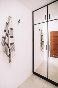 a room with a glass door and a mirror at Apartament Blue Sky in Hel