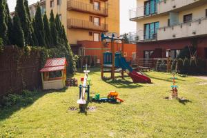 a yard with a playground with a slide at Apartament Blue Sky in Hel