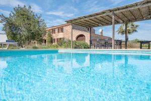 a large swimming pool in front of a building at Finca Es Casal by Mallorca House Rent in Sant Llorenç des Cardassar