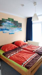 a bedroom with a bed with red pillows at RuheZeit - inclusive Pool & Sauna in Bad Harzburg