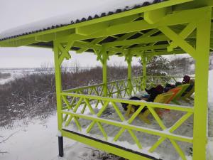 a group of people sitting in chairs in the snow at Dacha Zabugorische in Antipovka