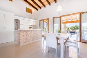 a kitchen and dining room with a table and chairs at Finca Sa Vinya by Mallorca House Rent in Felanitx