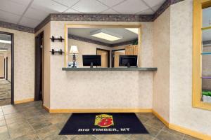 a large mirror in a office lobby with a big turkey sign at Super 8 by Wyndham Big Timber in Big Timber